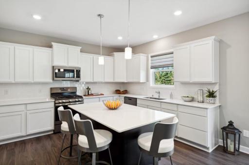 Lewis Standard Kitchen, range will be different, island will be white in actual home. *Please note, photos are of a similar model home, features and colors in actual home will vary. Please contact listing agent for exact specifications.