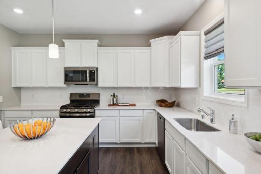 Lewis Standard Kitchen. Island will be white in actual home. Range will be different, see other photo *Please note, photos are of a similar model home, features & colors in actual home will vary. Please contact listing agent for exact specifications.