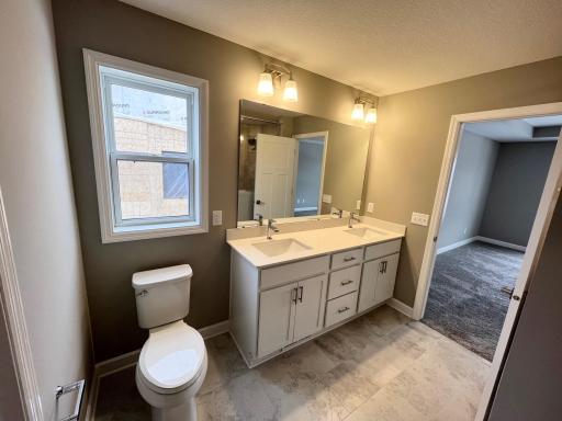 Primary suite serenity bathroom. Faucets will be different see another photo. *Please note, photos are of a similar model home, features and colors in actual home will vary. Please contact listing agent for exact specifications.
