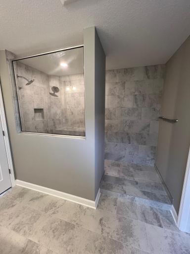 Serenity bathroom walk in shower with 2 shower heads. *Please note, photos are of a similar model home, features and colors in actual home will vary. Please contact listing agent for exact specifications.