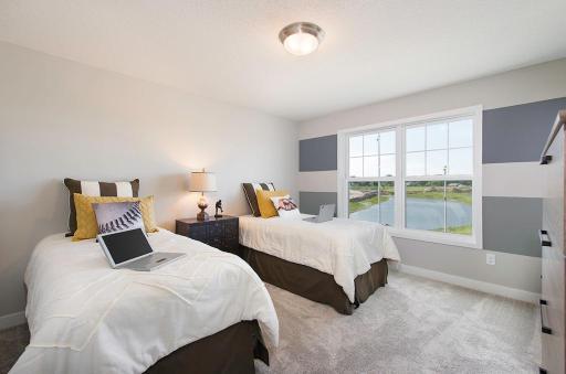 One of four upper level bedrooms. *Please note, photos are of a model, features and colors in actual home will vary. Please contact listing agent for exact specifications.