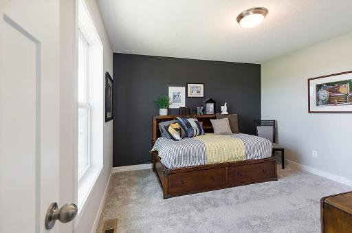 One of four upper level bedrooms. *Please note, photos are of a model, features and colors in actual home will vary. Please contact listing agent for exact specifications.