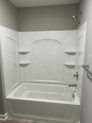 Hall bathroom tub shower combo. *Please note, photos are of a similar model home, features and colors in actual home will vary. Please contact listing agent for exact specifications.