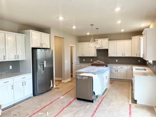 HUGE kitchen with tons of cabinets and stunning backsplash!