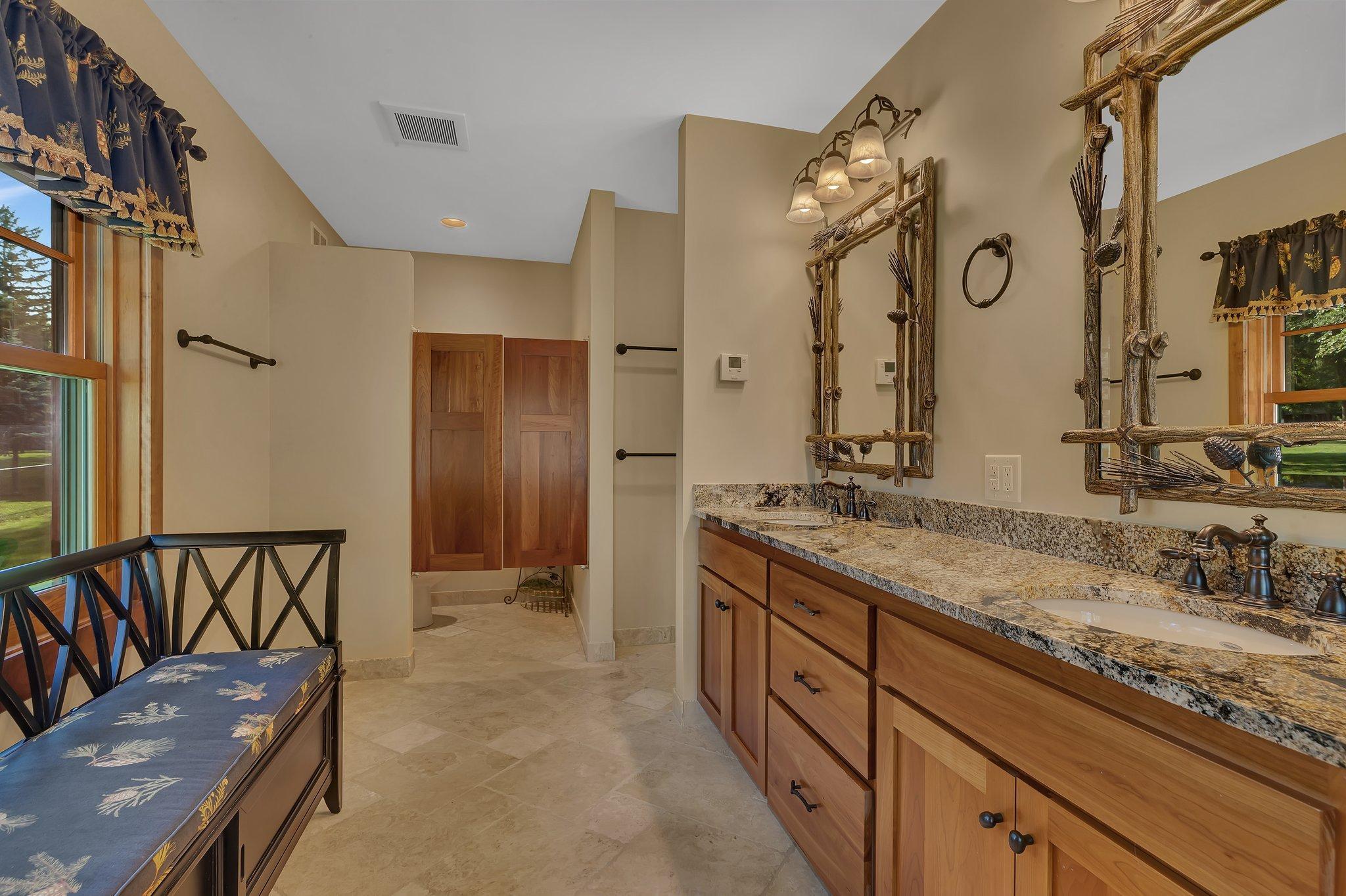 From gleaming granite double vanities to rich hardwood cabinetry, every surface exudes elegance and sophistication.