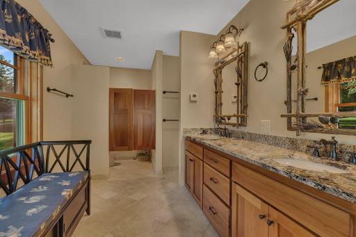 From gleaming granite double vanities to rich hardwood cabinetry, every surface exudes elegance and sophistication.
