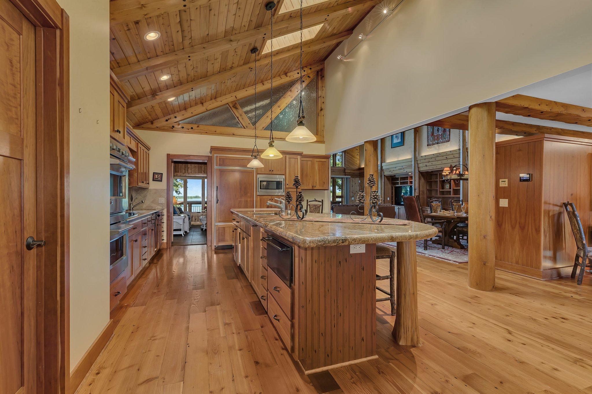 The heart of the home is the gourmet kitchen, equipped with state-of-the-art appliances, granite countertops, and a spacious island that invites culinary creativity.