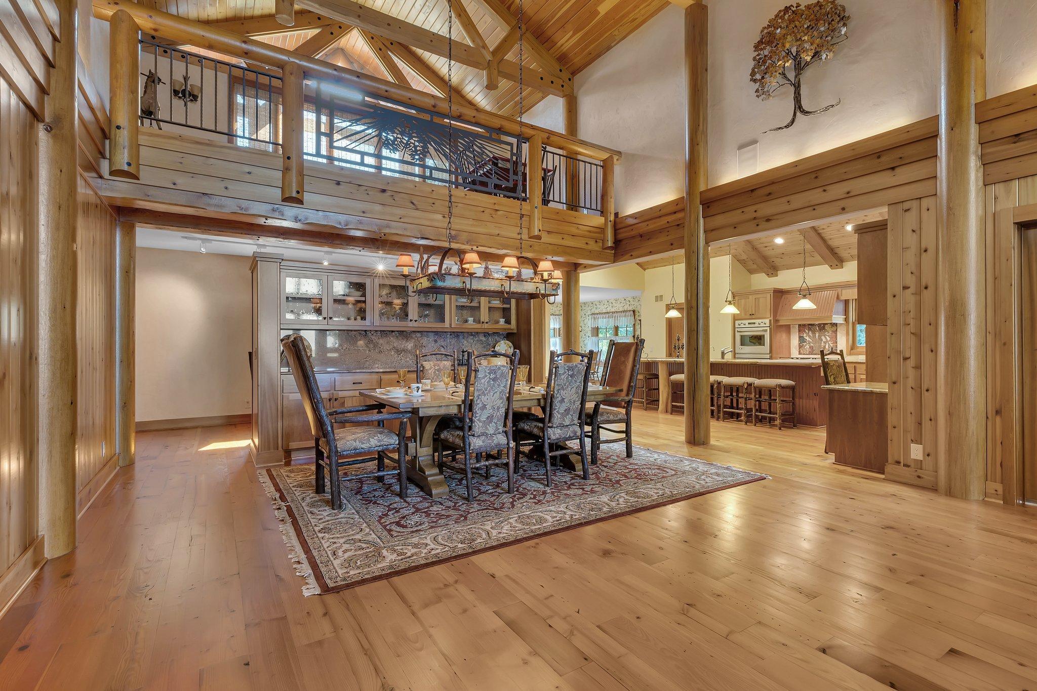 Enter the dining room area, where vaulted ceilings seemingly touch the sky and invite the warmth of natural light. Enjoy wonderful meals with family and friends here.