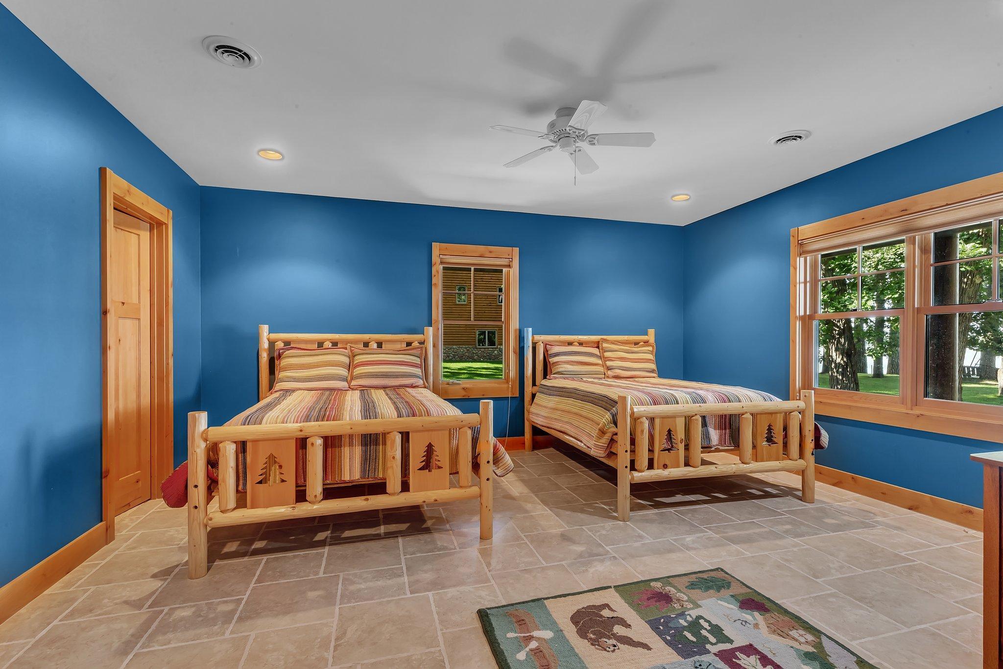 Additional bedrooms offer comfort and privacy for guests, each with a bathroom en suite. 1st of 3 lower level bedrooms.