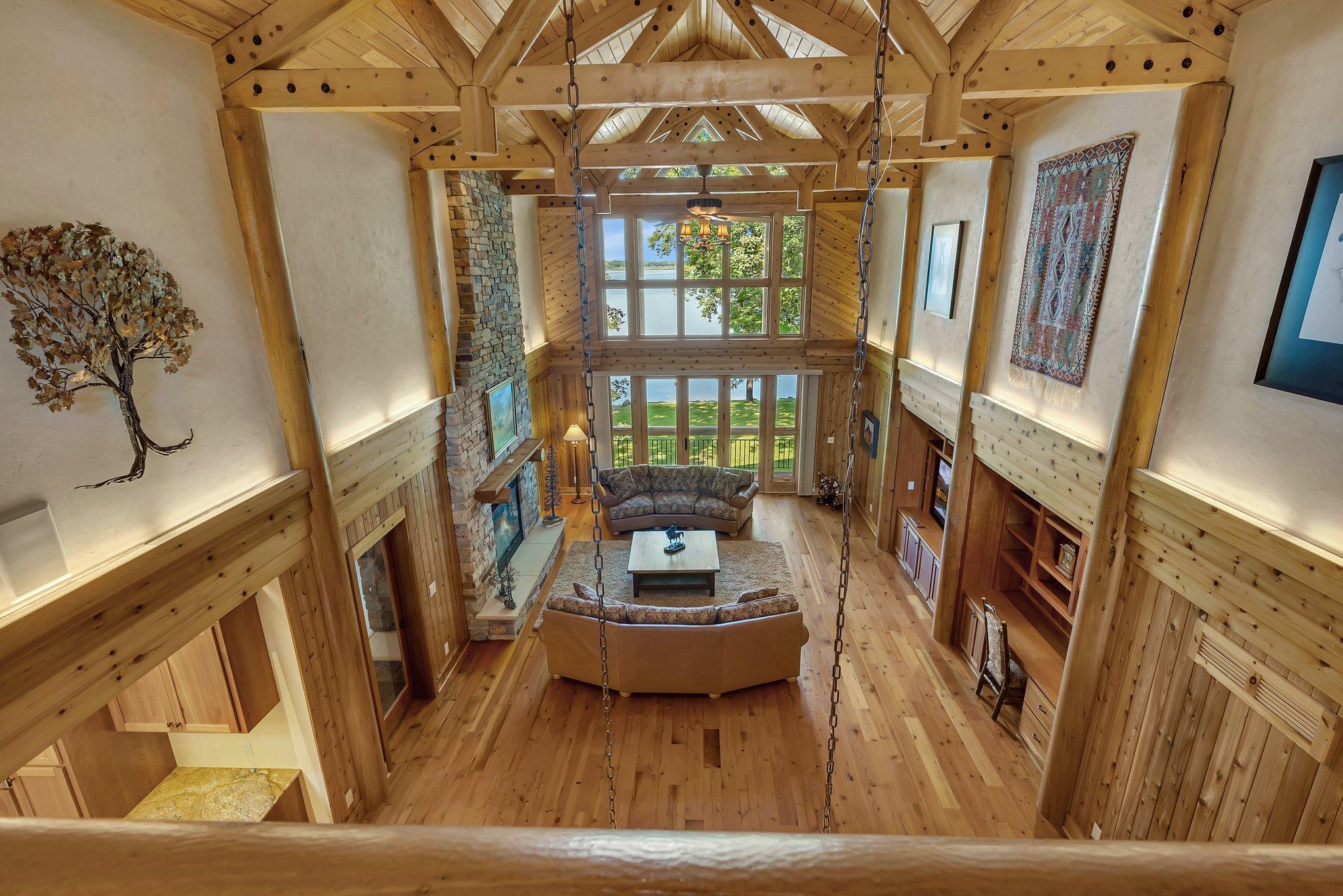 The open-concept living area features vaulted ceilings adorned with wood beams, creating a spacious yet cozy atmosphere.