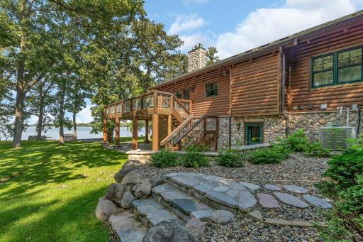 Outside, a spacious deck offers an extension of the home's living space. It's the ideal spot to savor your morning coffee, relax as the sun sets over the tranquil waters, or to stargaze as the night sky twinkles above.
