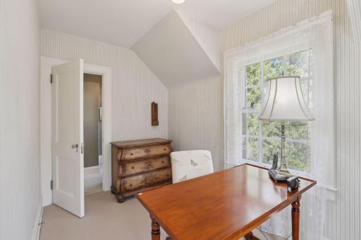 4th bedroom with direct access to a 3/4 bath. Cozy space to use as a small bedroom with a twin bed or a great office space just up the stairs from the kitchen.