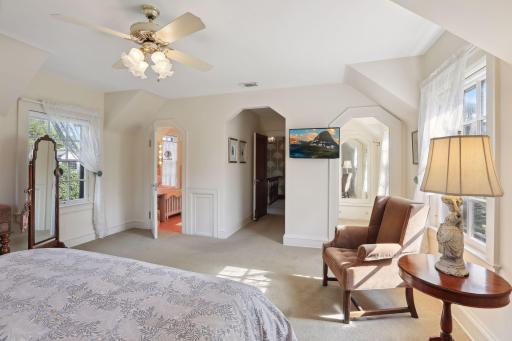 Primary suite with full bath featuring original tile and a walk in closet. Charming architectural details.