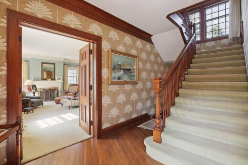 Spacious formal living areas on the main level and a wide staircase leading to the bedroom level.