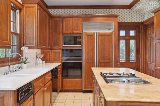 Center island kitchen with kitchen window overlooking gardens.