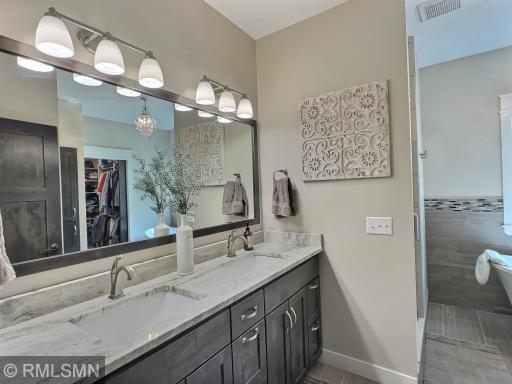 There is enough room for the both of you in the en-suite offering double sinks boasting a gorgeous quartz countertop.