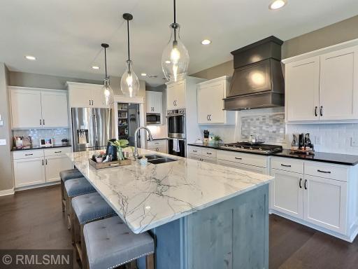 Entertain in style with this amazing kitchen complete with massive center island, walk-in pantry and pendant lighting.
