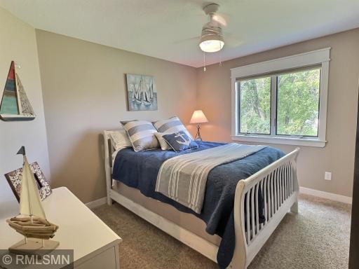 The first bedroom upstairs offers a ceiling fan, carpet, nice closet and great views. Great for a kids or guest room.
