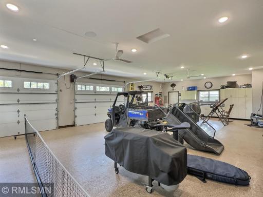 The detached double garage includes exposed aggregate flooring, sink, cabinets and a half bathroom.