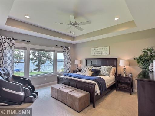 The primary suite also offers those stunning trey ceilings and was designed to showcase the views of the amazing shoreline.