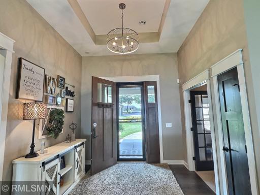 Welcome home, this grand foyer is accented with a stunning trey ceiling and offers wood flooring and coat closet.
