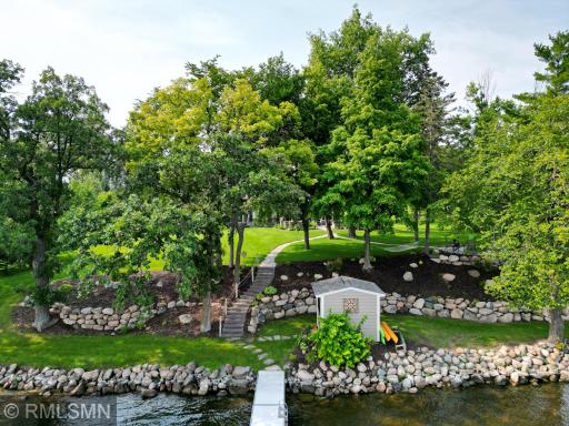 Remarkable boulder landscaping, towering trees and mature landscaping edge the 155 feet of impressive Sugar Lake shoreline.