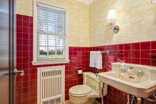 Main floor full bathroom with tub, charming original tile.
