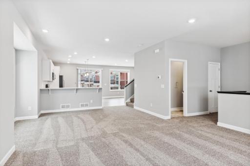 Large family room with open floorplan. Photos are not of actual home. Actual home will be similar. Some colors and features may vary.