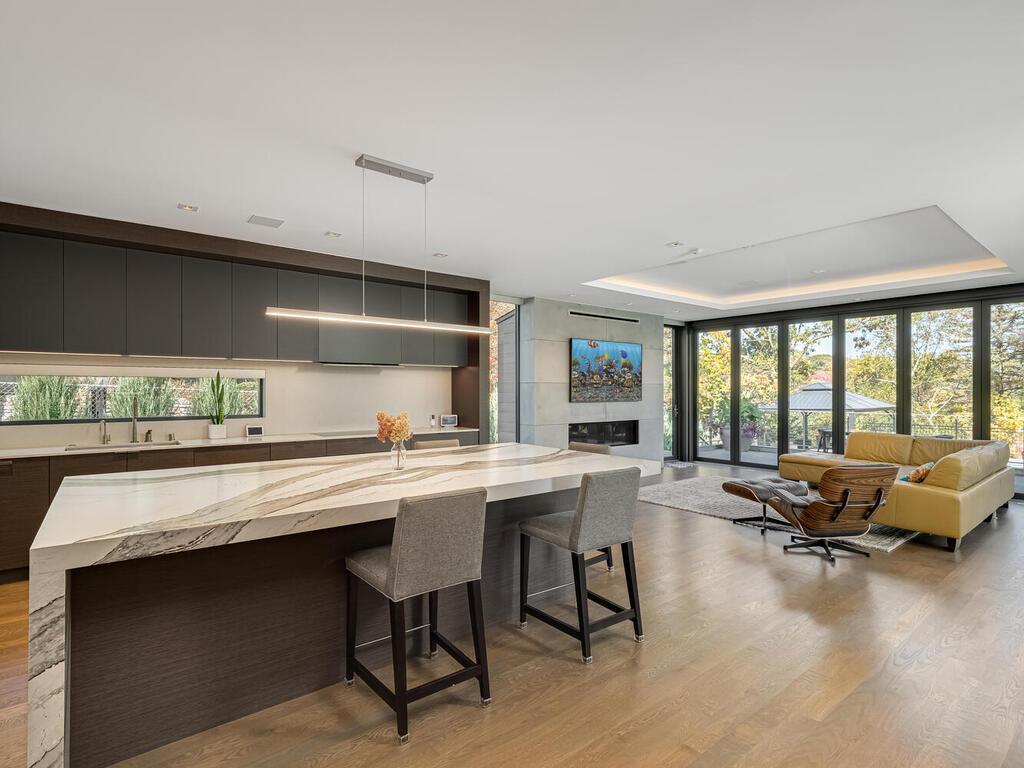 Kitchen is open to Family Room with gas fireplace and retractable back wall with double fantom screens.