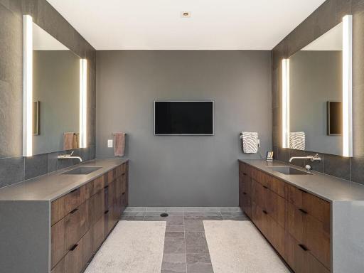 Custom double vanities with quartz countertops and built-in electrical outlets in drawers