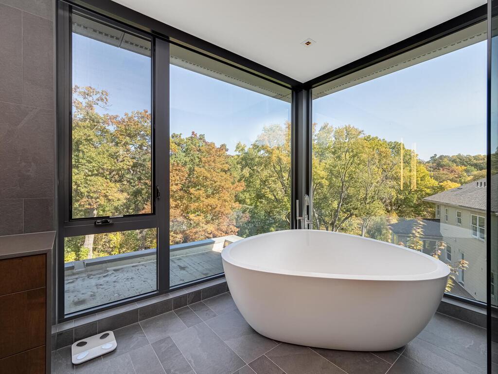 Primary soaking tub with electric shades for privacy