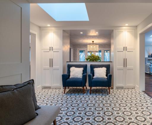 spacious skylit foyer with custom storage