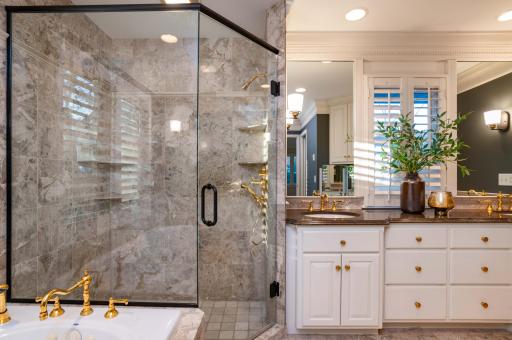 oversized stone shower and tub in luxurious primary bath