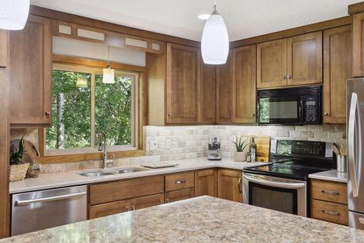 Photo for 899 Millwood Avenue, Roseville, MN 55113 - Listing #6423463 Adorned with stainless steal appliances that seamlessly integrate into the cabinetry, this space marries form and function effortlessly.