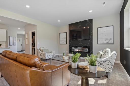 Seamlessly connected to the kitchen, the home's main level family room features a electric fireplace. Imagine watching a family movie, relaxing after a day of work or entertaining neighbors in this space!