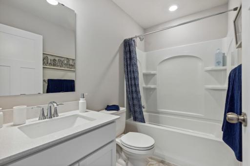 This stunning full bath is one of two baths located on the home’s upper level.