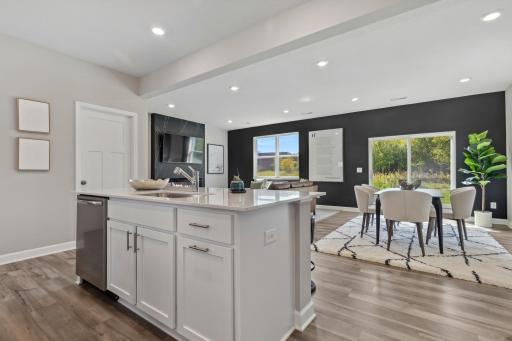 This spacious and open main level seamlessly connects to the kitchen area, perfect for entertaining. It also features many large windows providing abundant natural light.