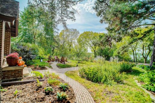 Enjoy a glass of wine with friends in the front garden patio with lake views and amazing sunsets