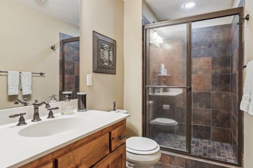 Â¾ bathroom featuring a walk-in tile shower.