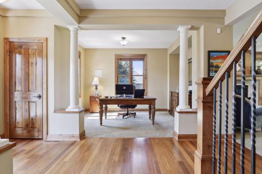 The foyer, flanked elegantly by a pair of decorative columns, welcomes guests. One's gaze is immediately drawn to the gleaming hardwood floors which extend throughout most of the main floor.