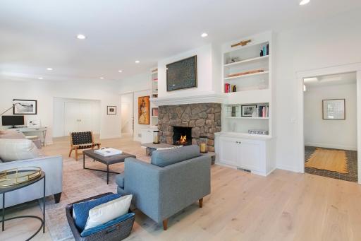 Expansive living room space with custom book shelves and mantel