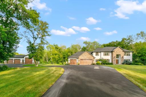 The finest details are evident throughout the home. Outside, the heated pool, stone fireplace, and multi-level deck provide the perfect setting for gatherings. The property also features stunning gardens, retaining walls, and serene wooded areas