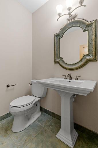 1/2 bath w/ charming pedestal sink & ceramic tile flooring