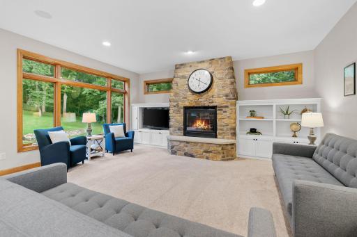 Gas fireplace with cultured stone surround and raised hearth in the Living Room