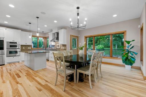 Informal Dining Room w/ full glass entry door w/ access to the maintenance free decks, pool and patio