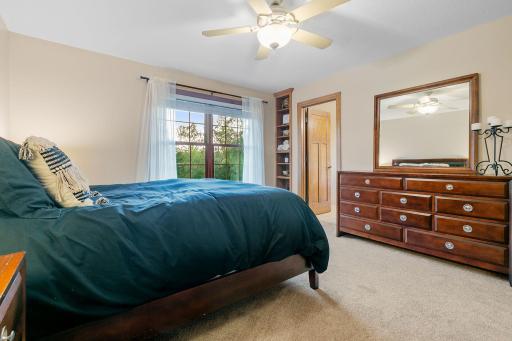 Bedroom 2 offers a walk-in closet w/ organizer, built-in bookcase & private full bathroom