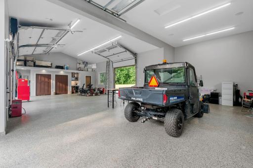 Out Building is painted & finished, radiant in-floor heating w/ epoxy finish & vaulted ceilings