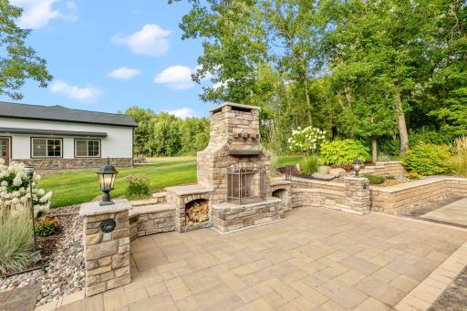 Partial decorative walls add built-in seating around the fireplace and offers both accent lighting and speakers