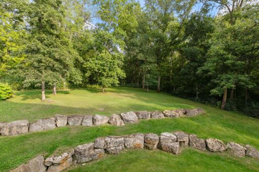 Tiered perennial gardens surround the pool and patio area