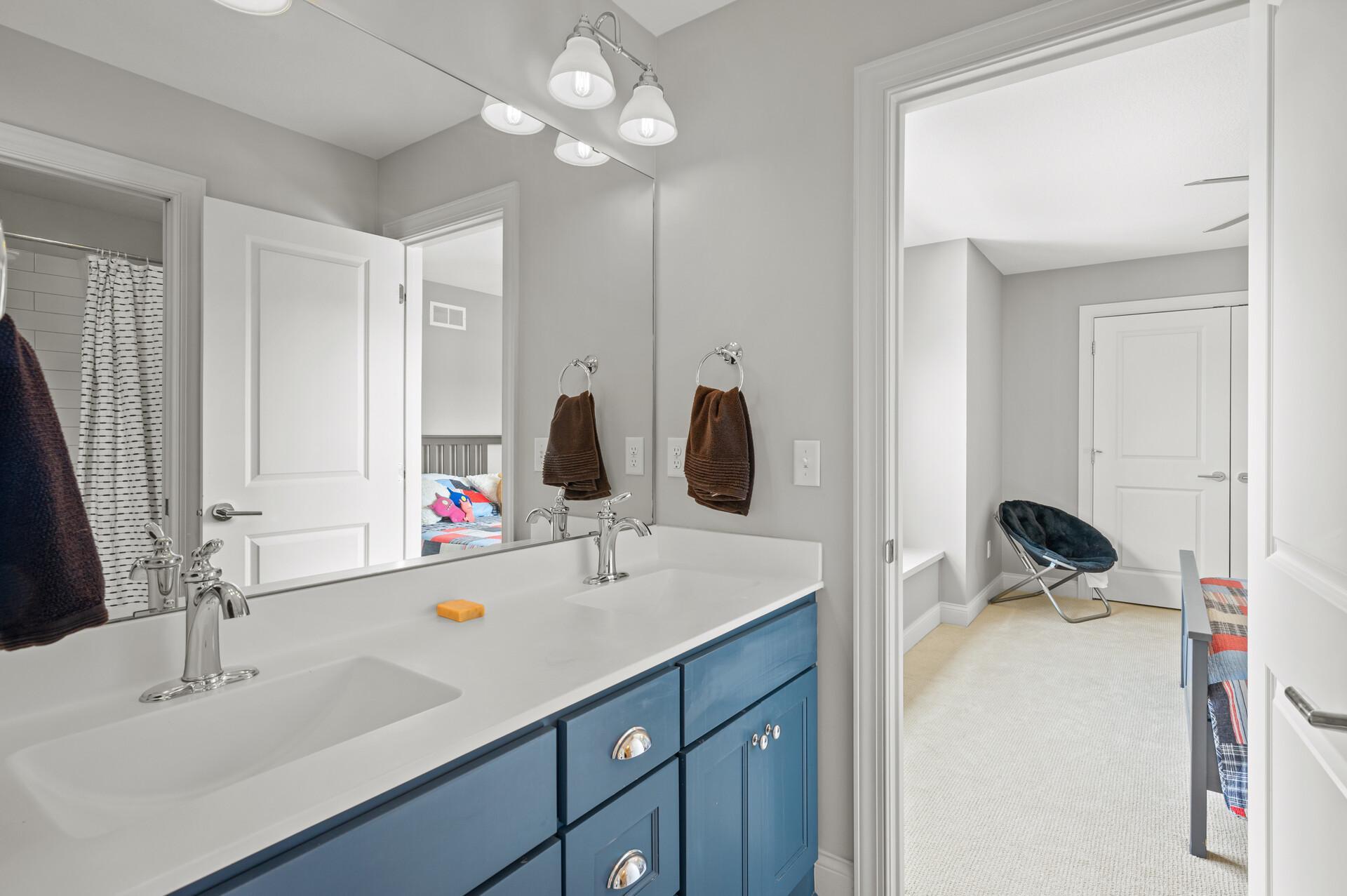 Jack & Jill bathroom with dual sinks, private water closet with tub/shower combo offering classy subway tile surround.